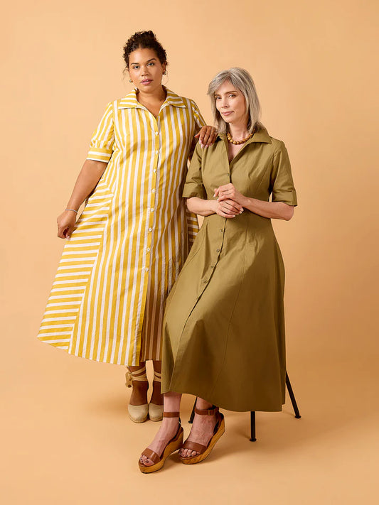 Two women wearing long, knee-length dresses against a beige background