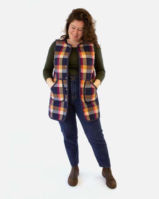 a person wearing a plaid quilted vest