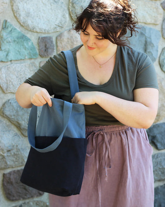 picture of someone looking down at an open costa tote