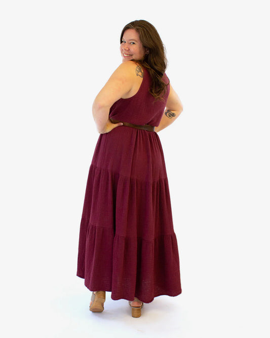 Woman wearing a burgundy dress on a white background