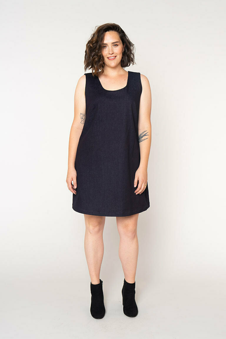 Woman wearing a black sleeveless dress on a white background