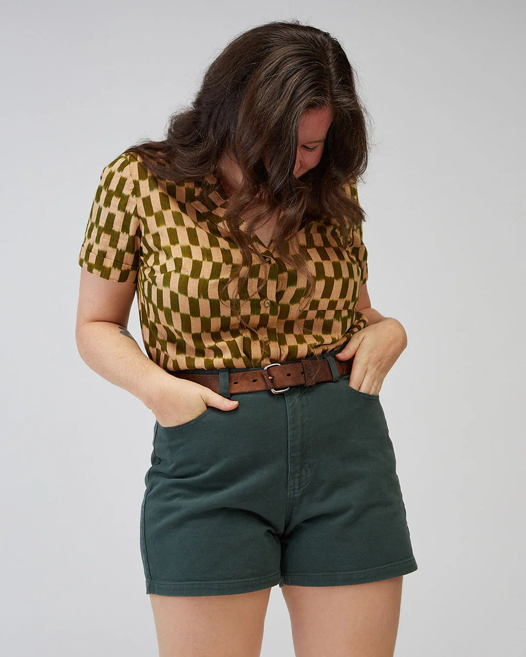 Closeup picture of person wearing Brooks jean shorts