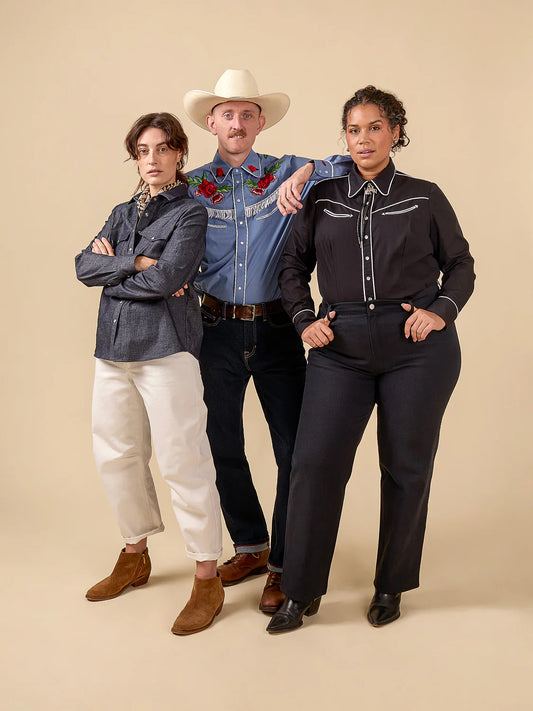 Three people wearing cowboy-style clothing against a beige background
