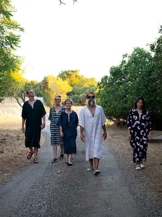2 man and 3 woman waking to the camera looking cool in those comfy tunics.
