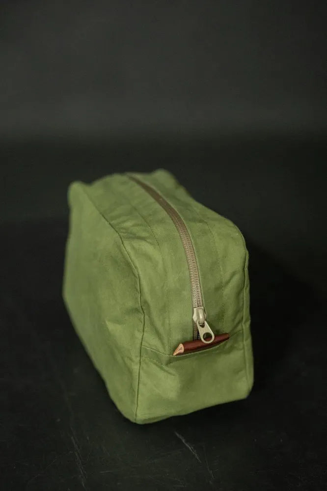 Green bag with a zipper on a black background