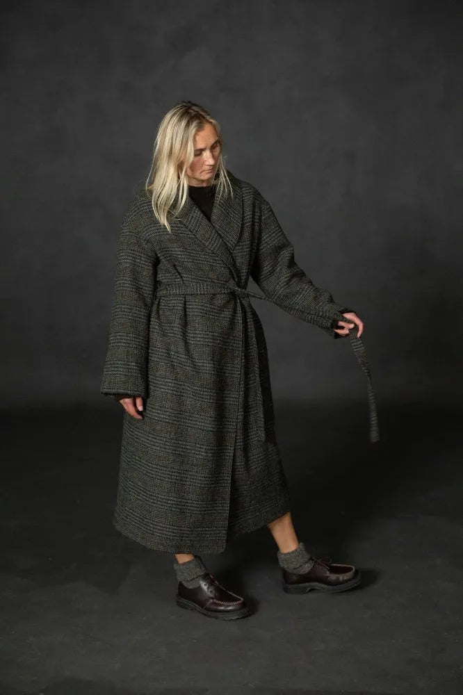 person modeling an dark tweed overcoat