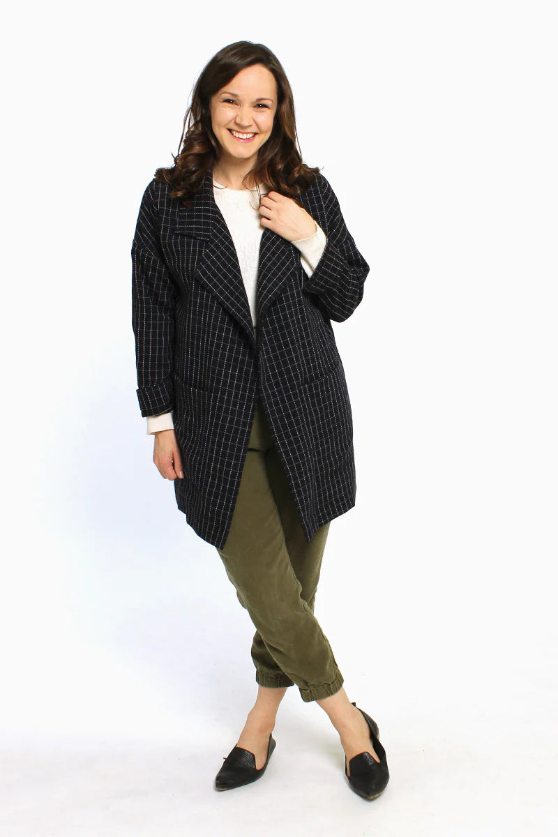 picture of a woman wearing a long jacket with pockets