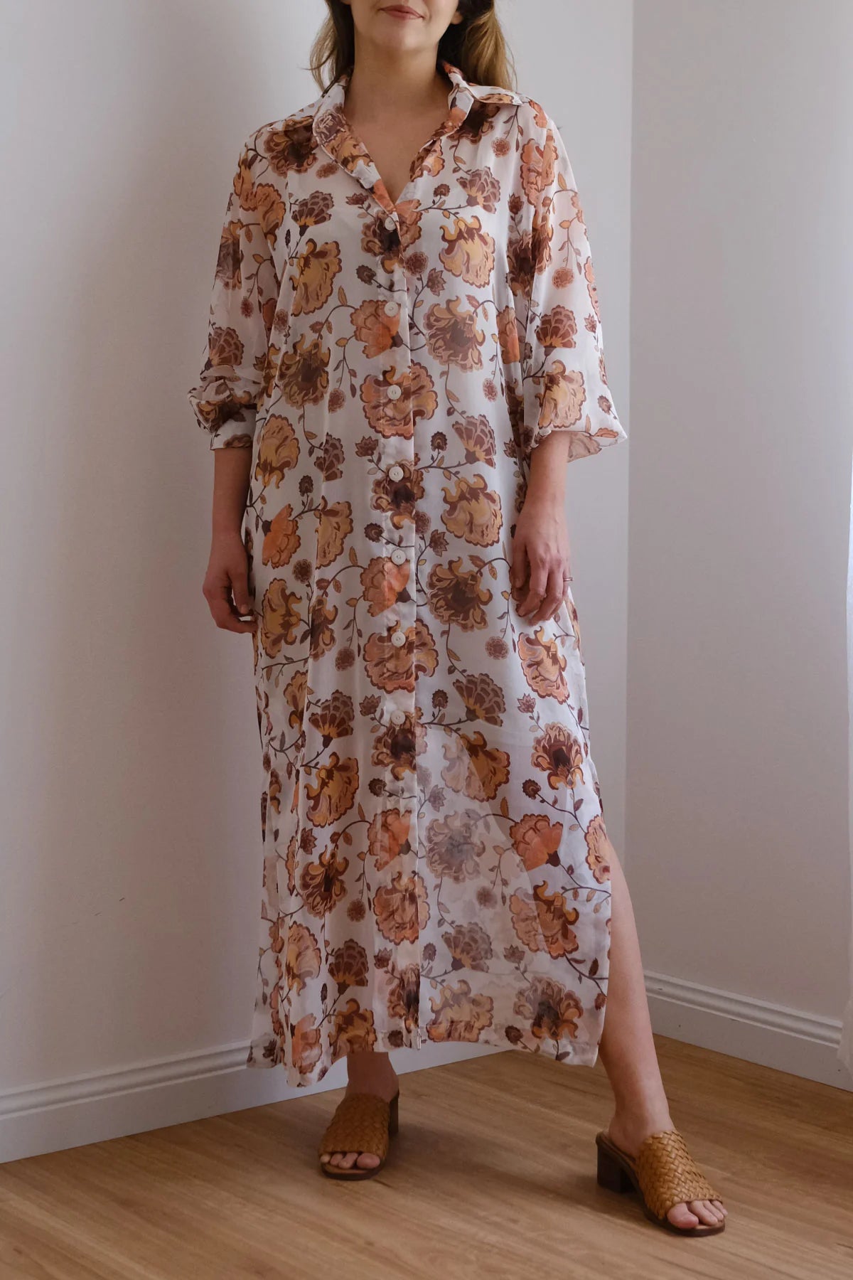 Woman wearing a floral dress with a neutral background