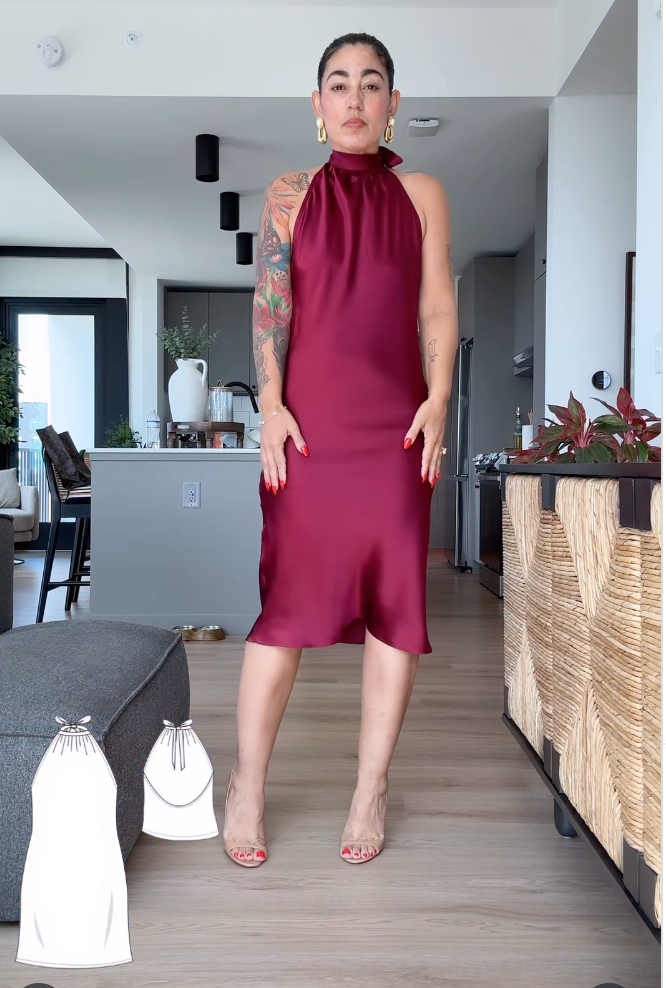 Woman wearing a burgundy dress in a modern living room.
