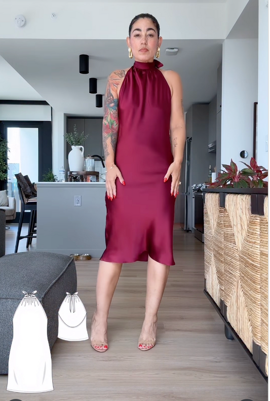 Woman wearing a burgundy dress in a modern living room.