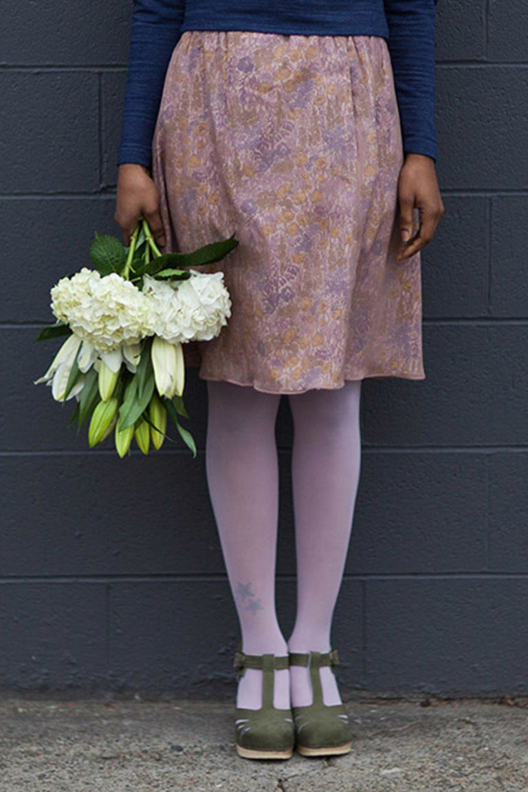 picture of a woman wearing a skirt of midi length in a lavender floral print