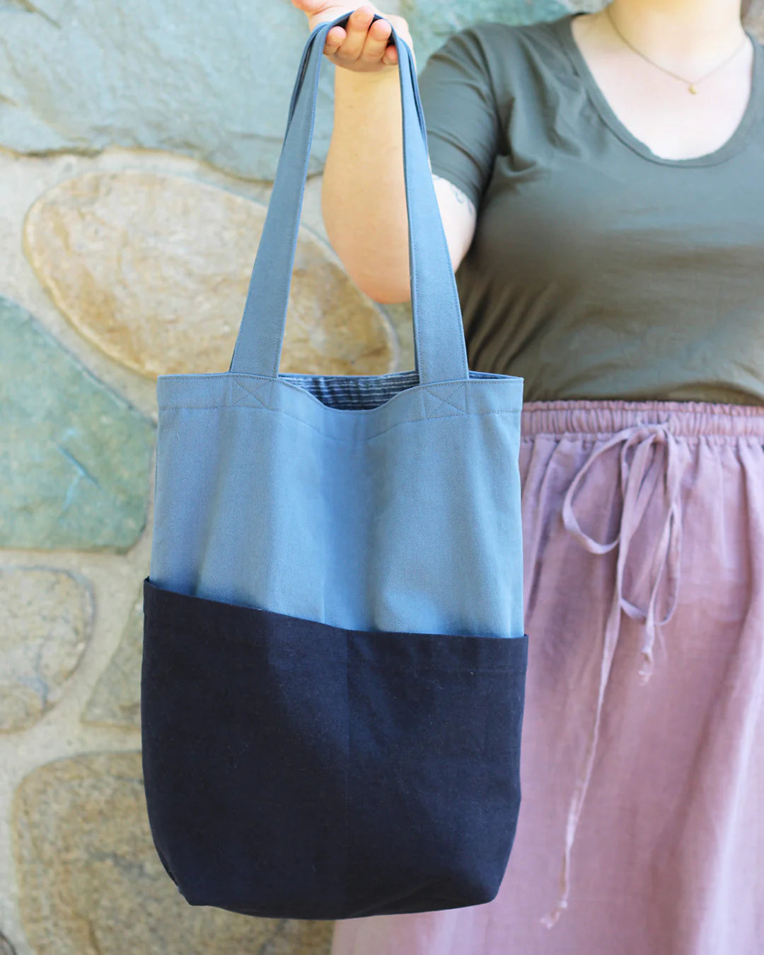 picture of costa tote being held out by someone