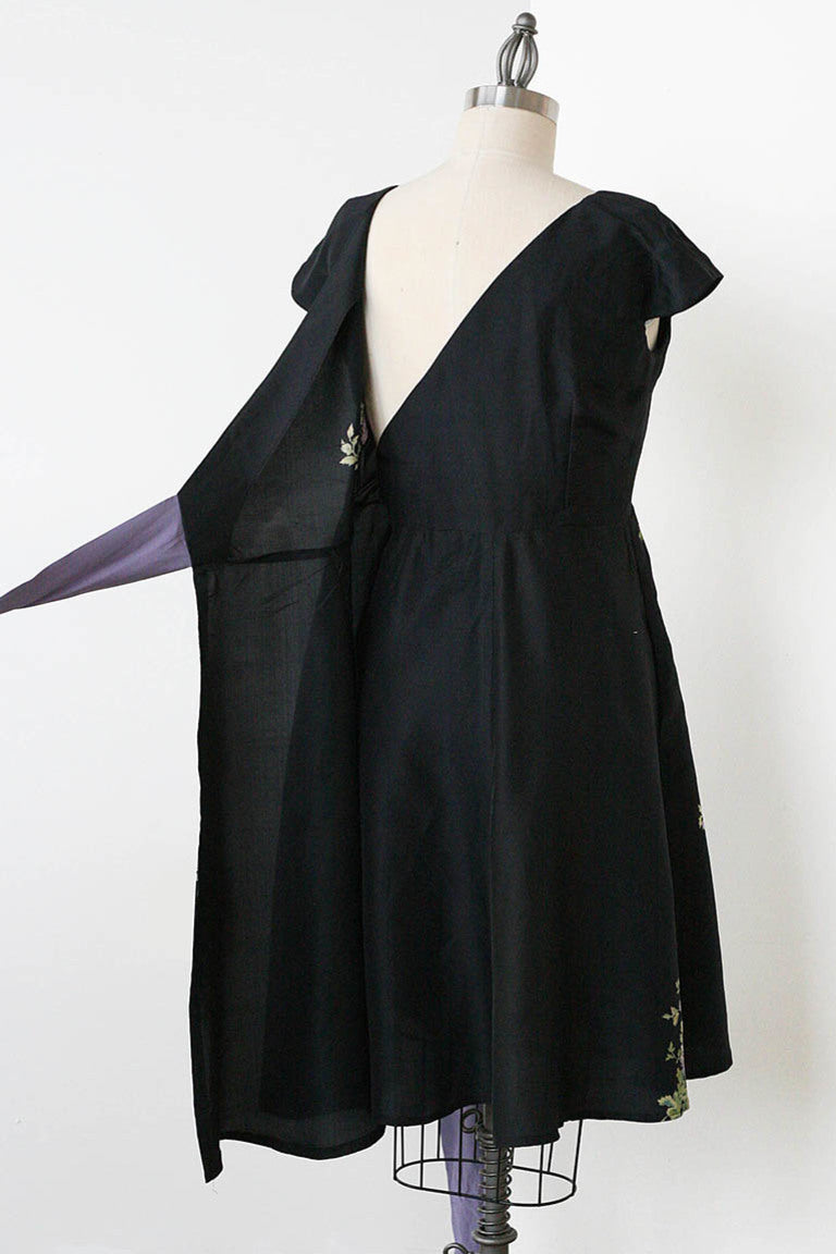 Black dress on a mannequin against a white background