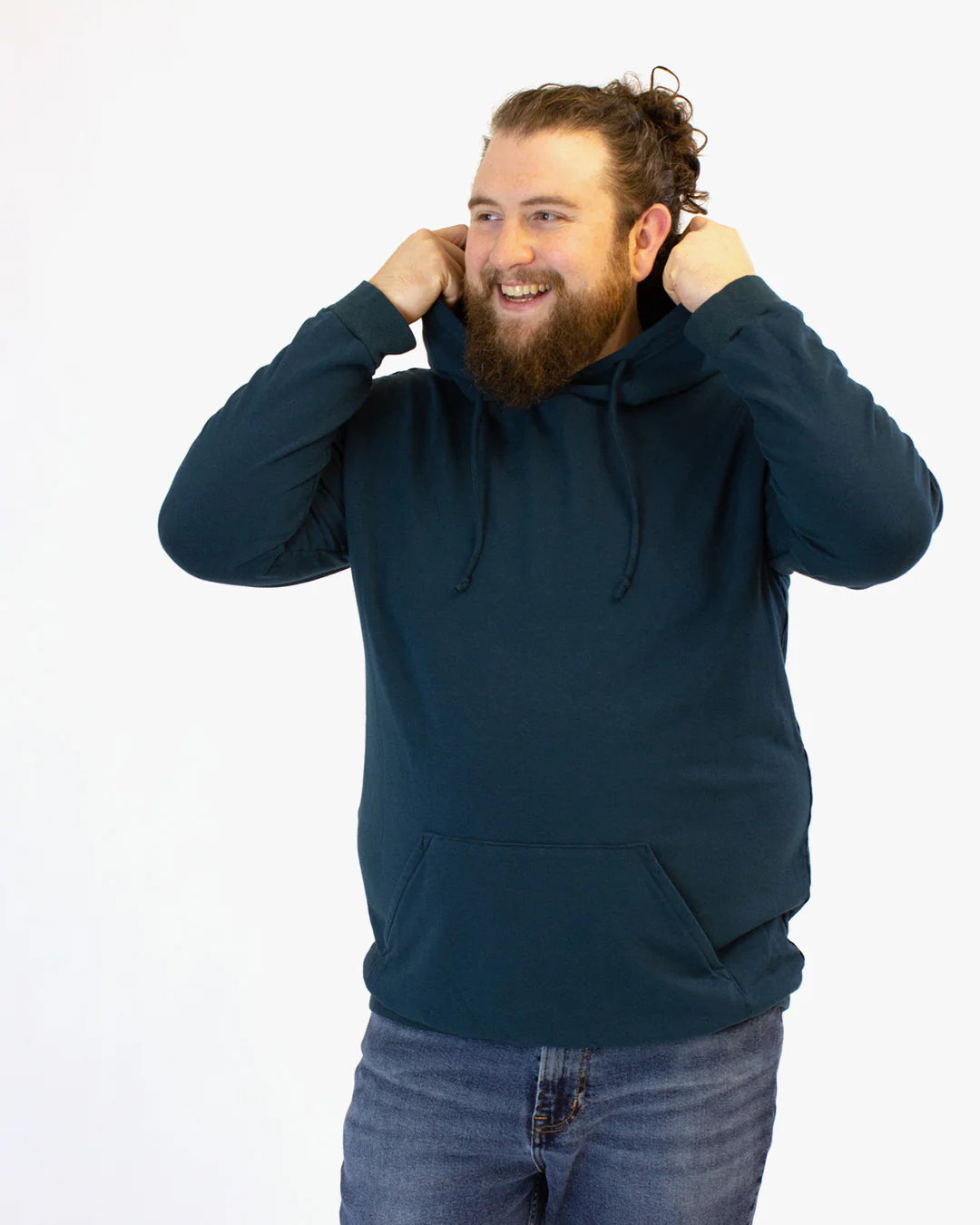 picture of person wearing a drawstring hoodie with kangeroo pocket pulling up hood