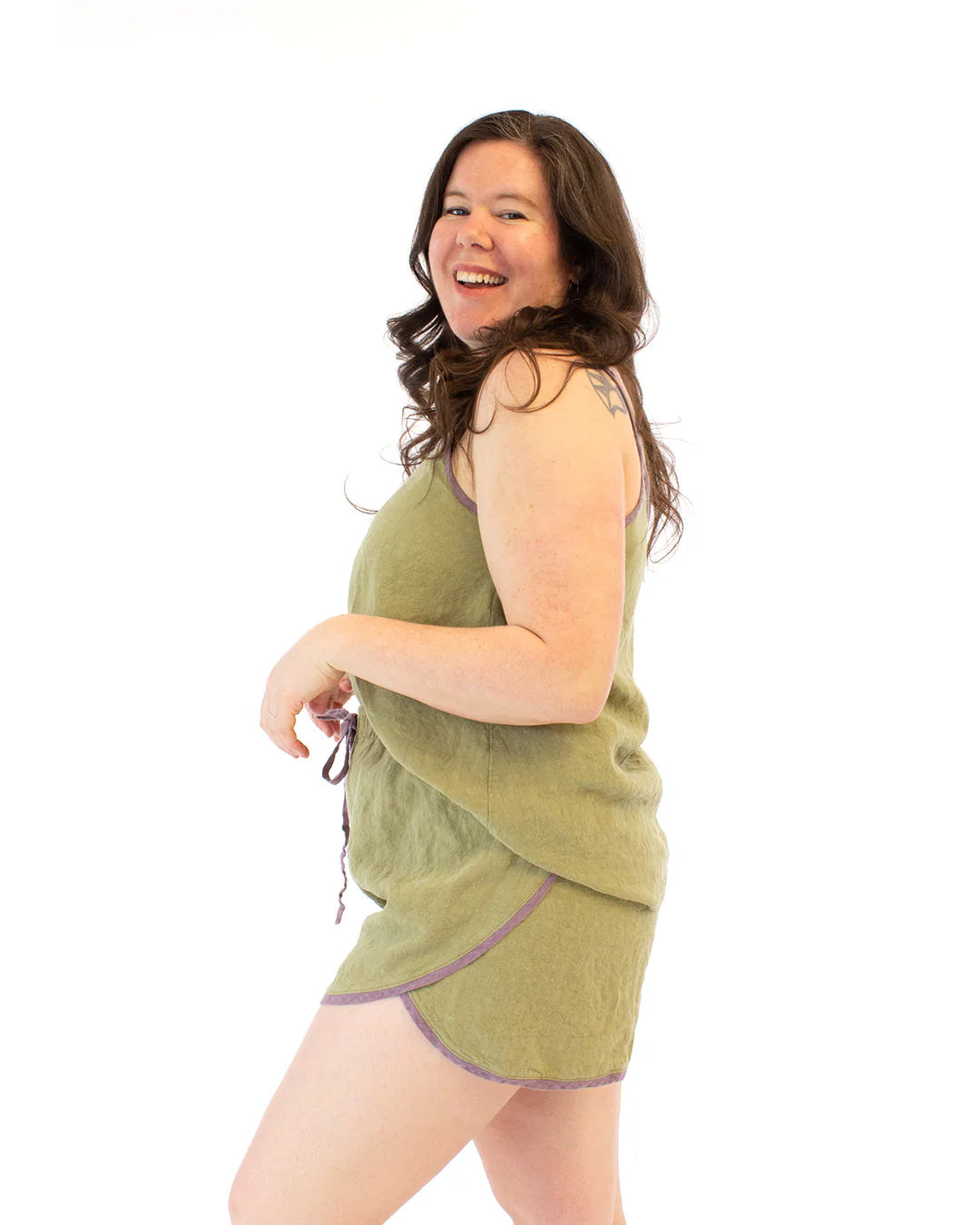 Woman wearing a green towel dress on a white background