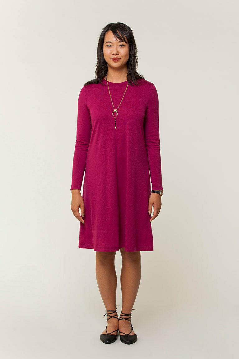 Woman wearing a magenta dress against a white background