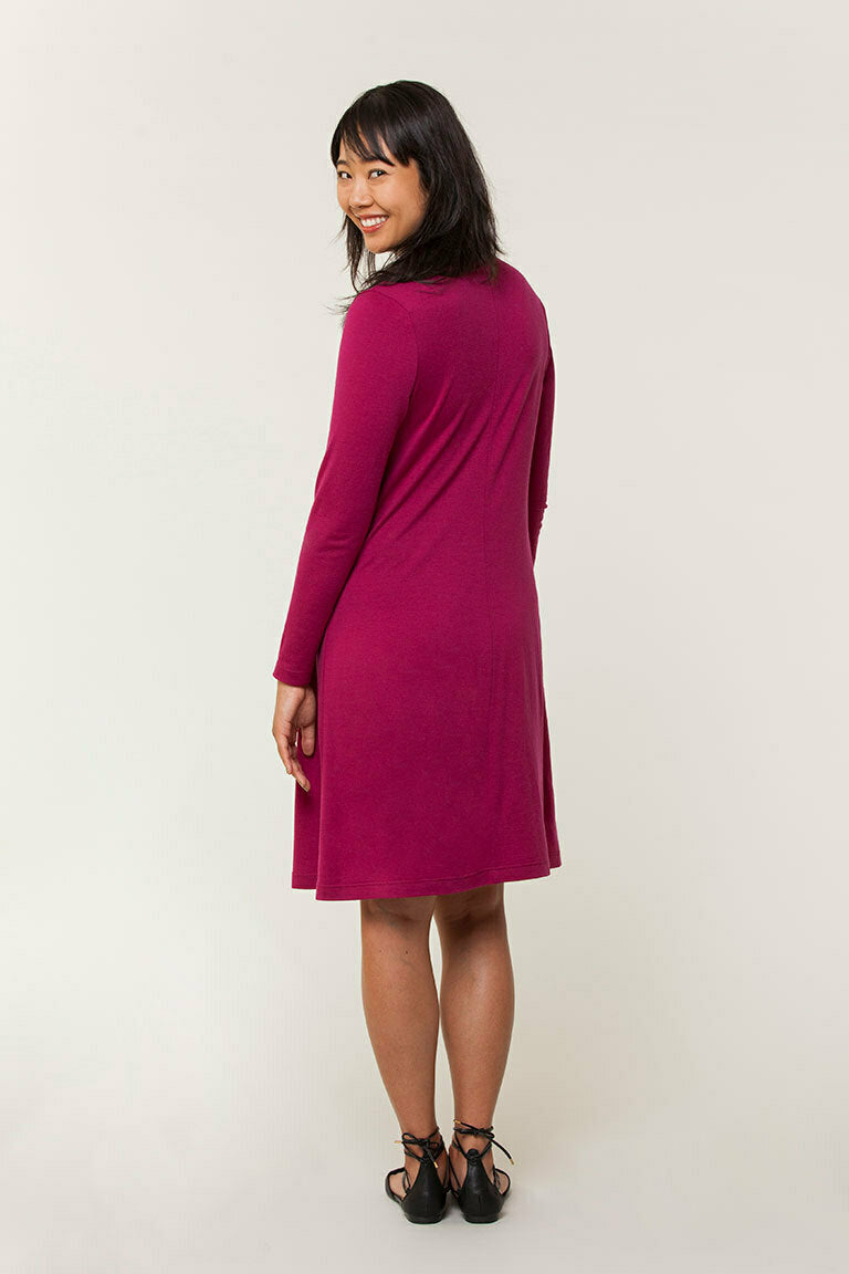 Woman wearing a magenta dress on a white background