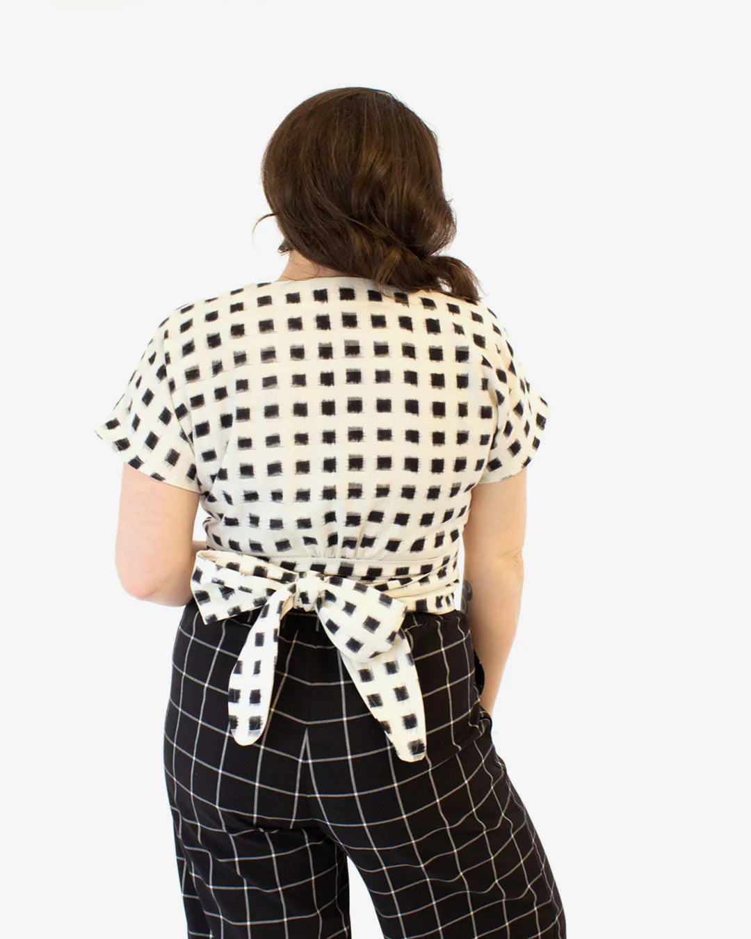 picture from the back of woman wearing short sleeve wrap cassidy shirt 