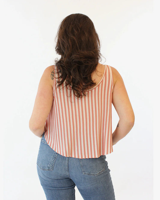 Person wearing a striped tank top and jeans from behind on a white background
