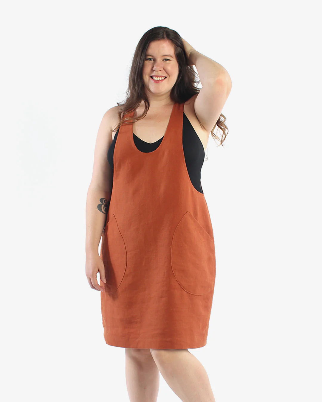 picture of woman wearing an orange color pinafore with side pockets