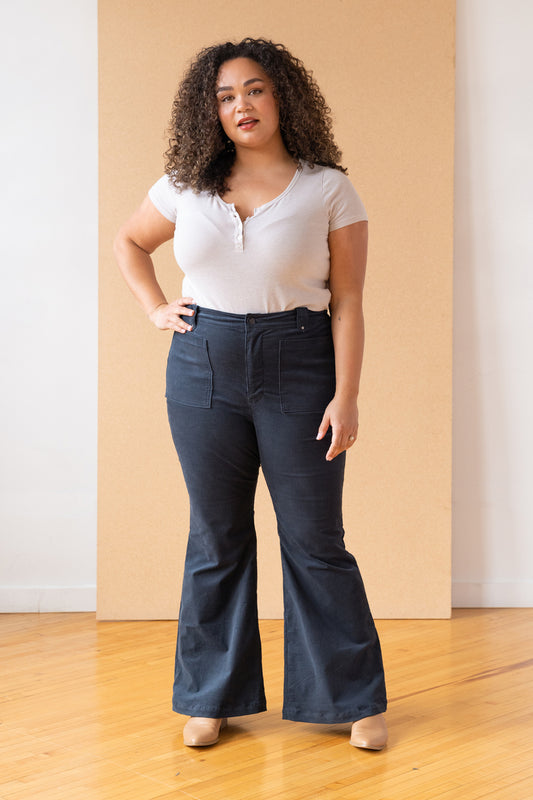 woman wearing flared jeans with a white top