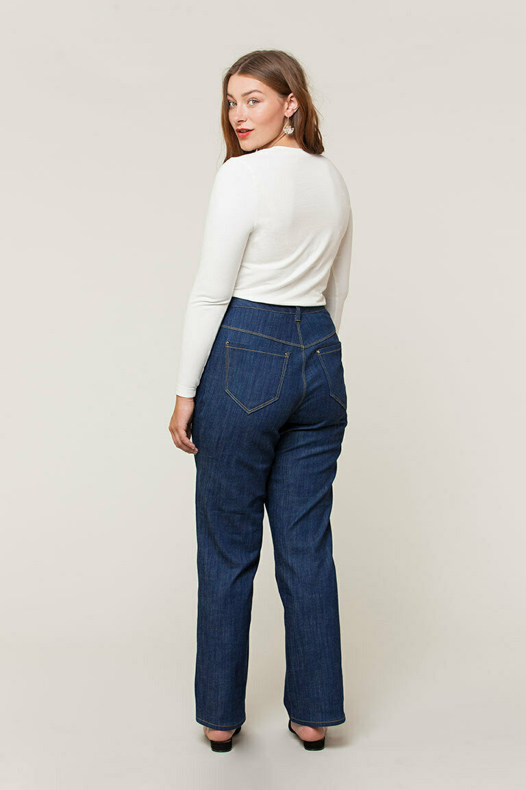 back view of woman wearing high waisted jeans with white tee shirt