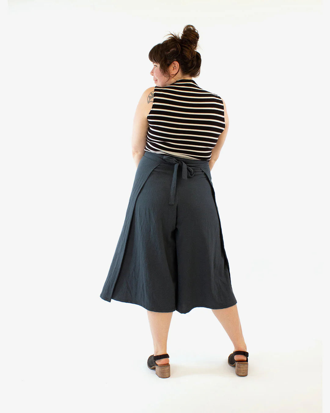 picture of woman wearing wrapped black culottes from behind